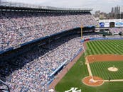 Aerial view of a crowded baseball stadium during a live game.